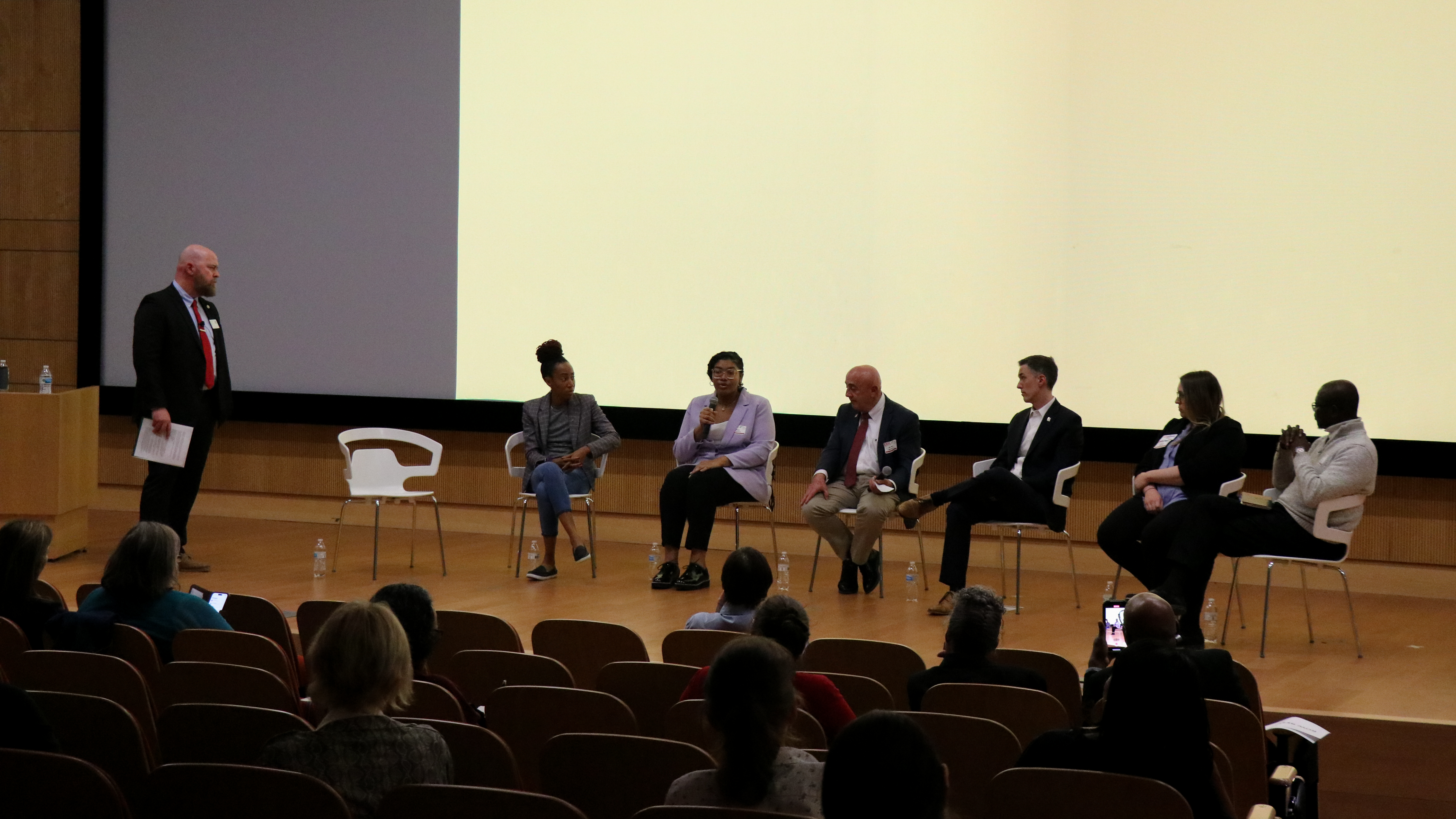 A group of professionals answering questions from a stage.