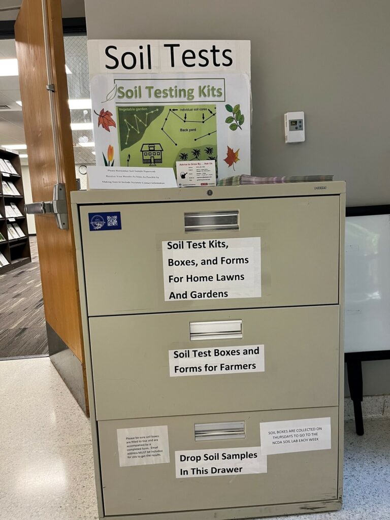 On the right side of the main entrance, there is a Soil Test file cabinet with test kits and a drop off station.