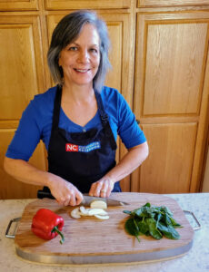 Margie Mansure, Watauga FCS agent, cutting vegetables.